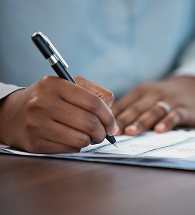 Male signing loan documents