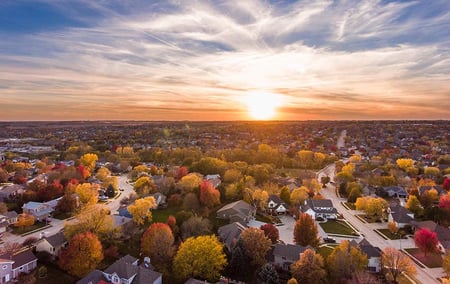 Beautiful suburbs with autumn colored trees against a scenic sunset