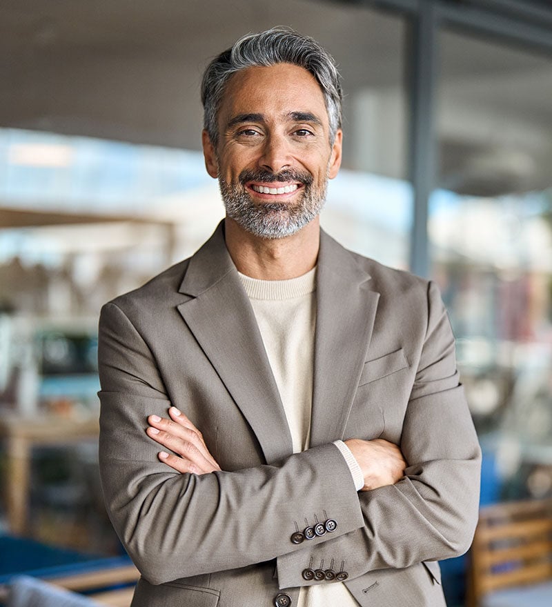 Investor smiling with arms crossed over his chest 