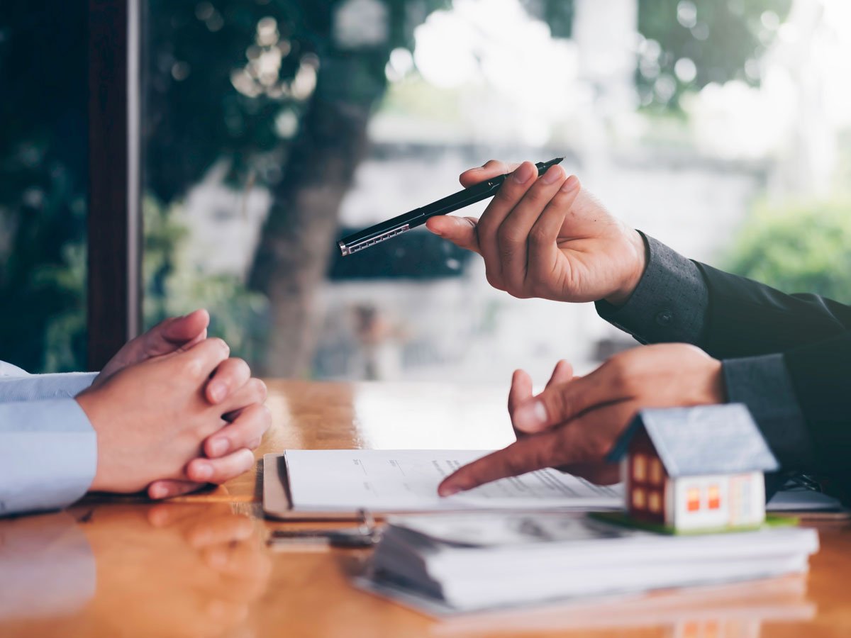 closeup of hands signing a loan agreement