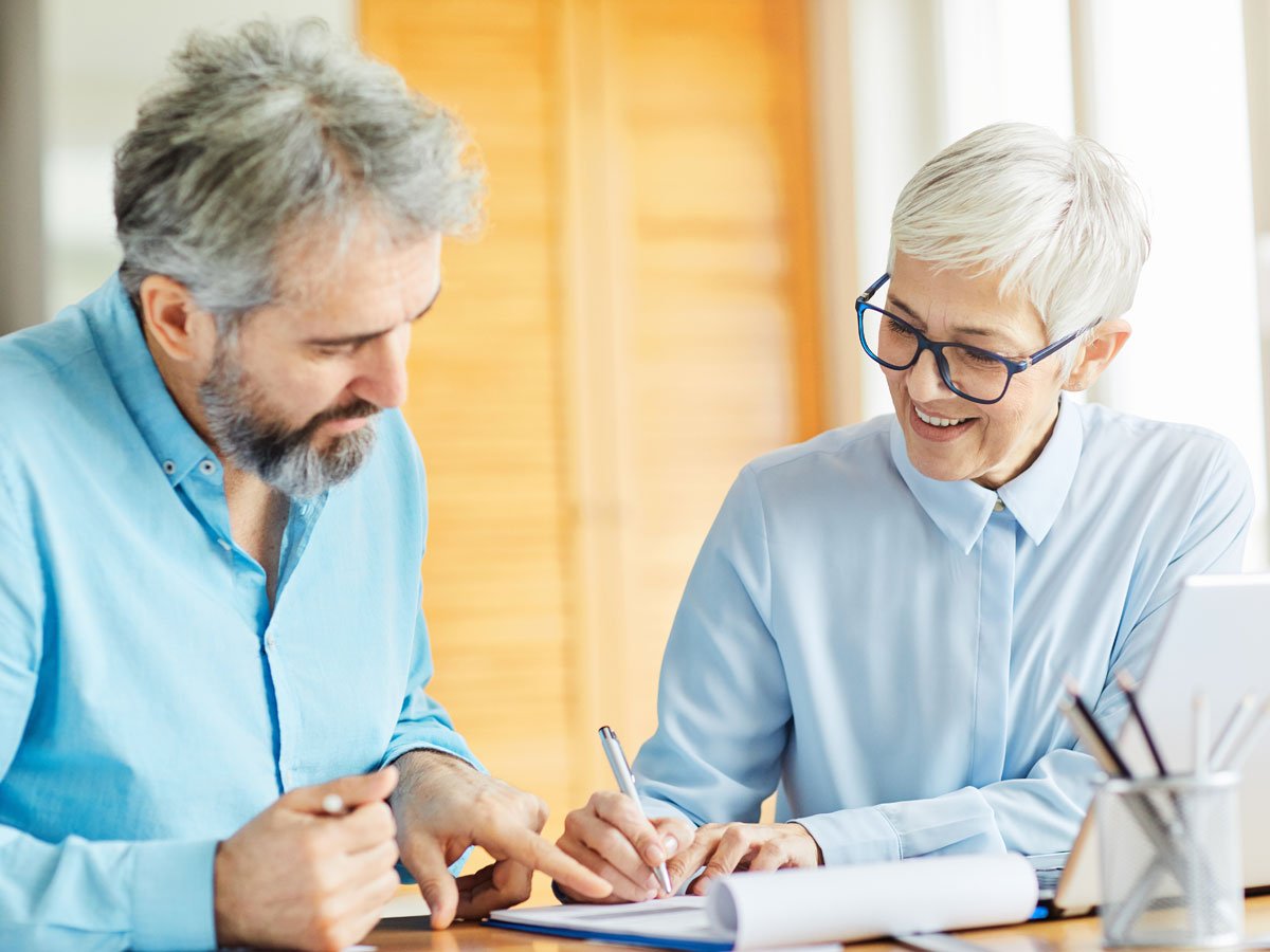 two people signing loan paperwork
