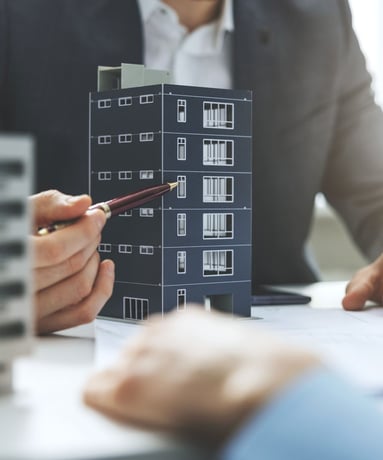 people reviewing building plans and models