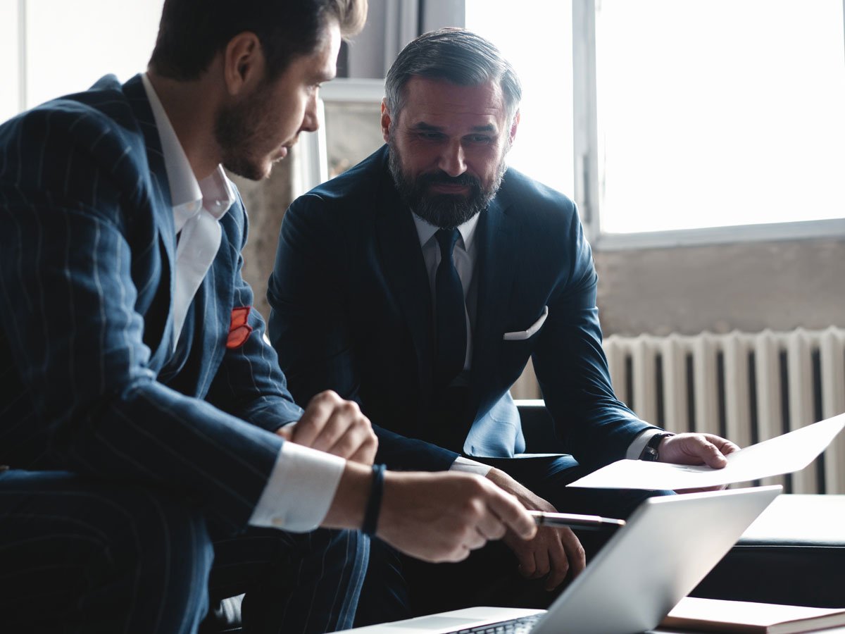 two men reviewing papers