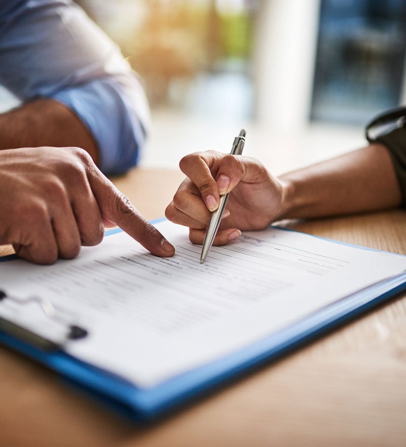 people signing documents