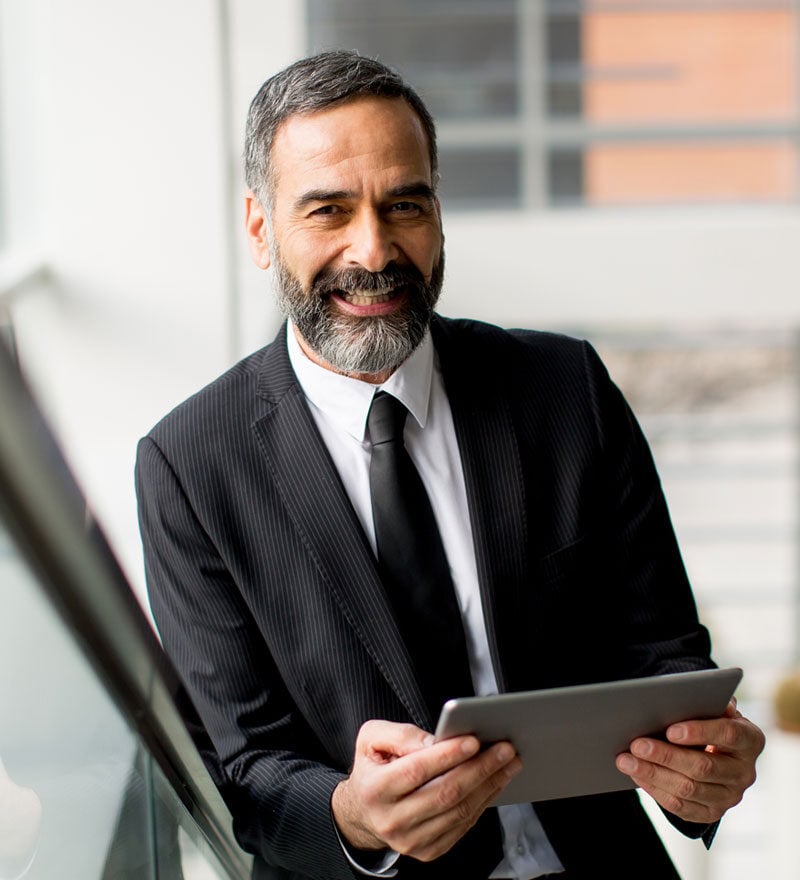 man in suit holding tablet