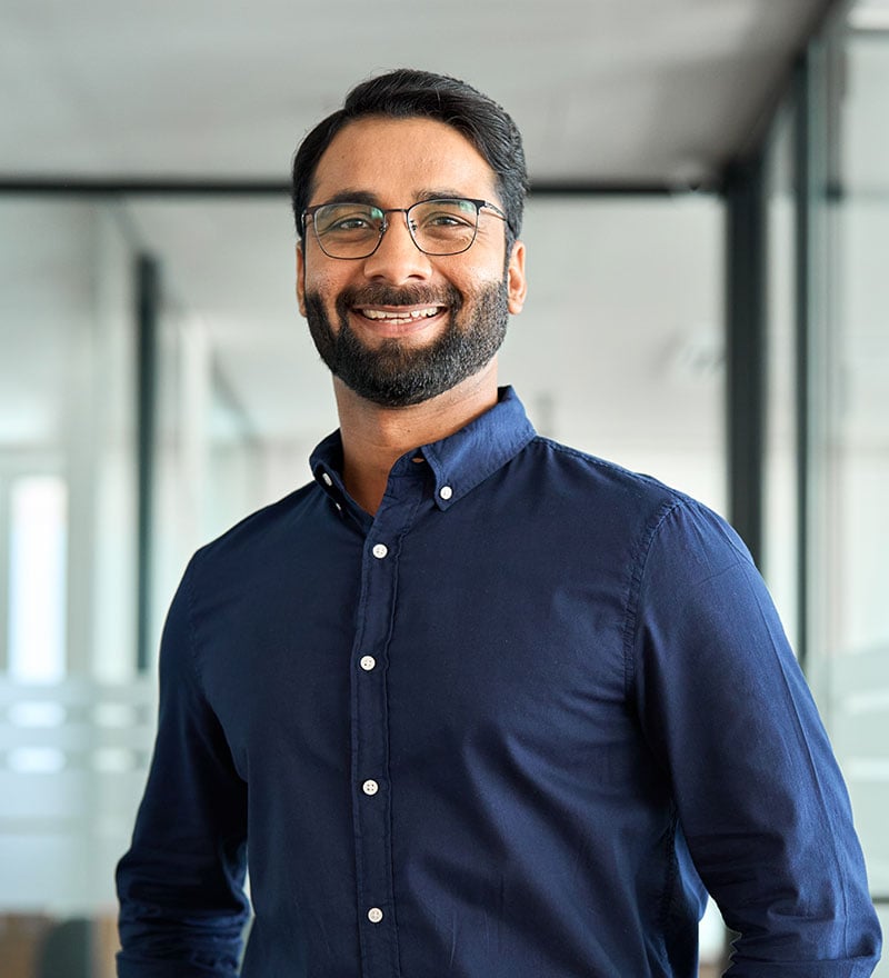 Male professional with an office as the backdrop